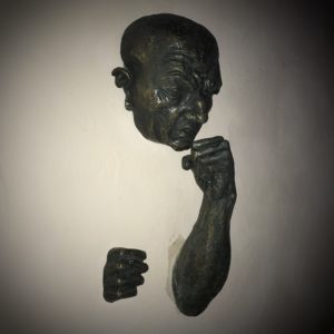 Statue of a man coming out of a wall boxing; Sculpture garden in Isla Mujeres, Mexico