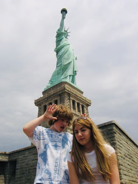 Boy and girl at Statue of Liberty during one of their top spring break vacations. 