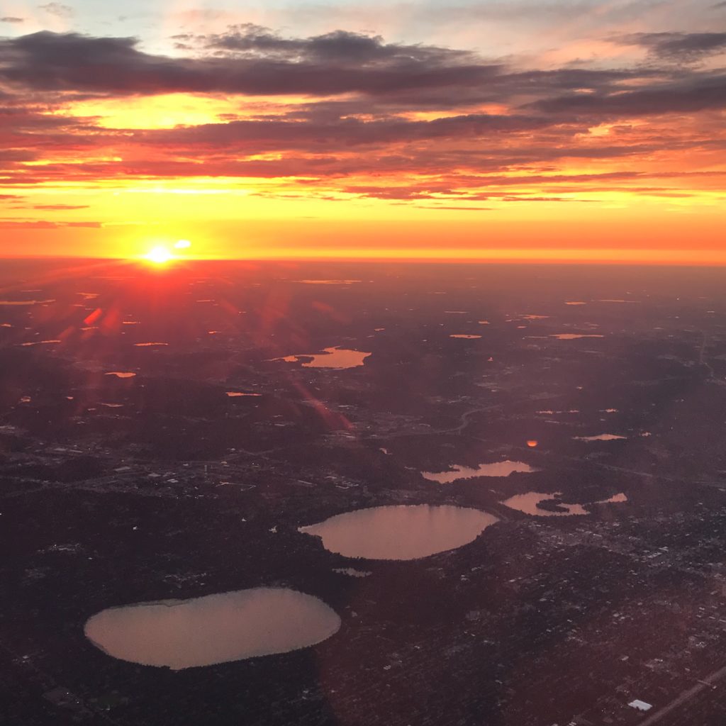 Aerial photo of a sunset and Minneapolis, Minnesota lakes taken from airplane