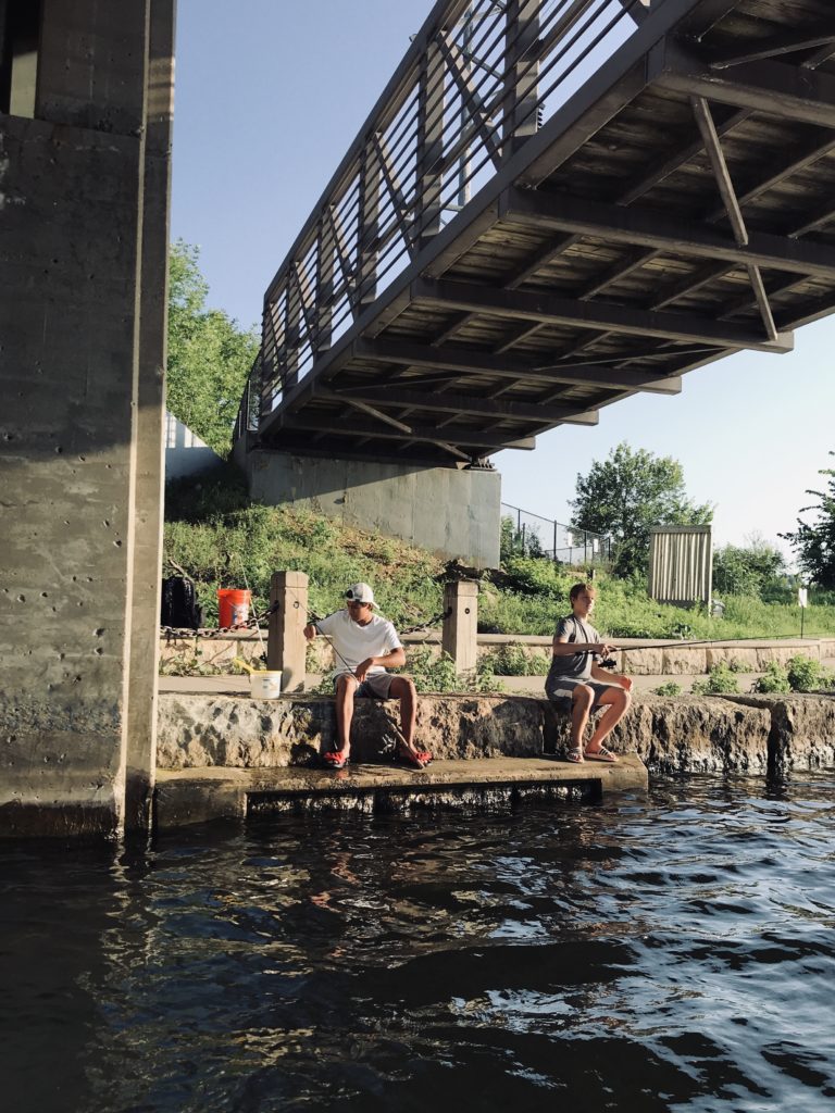 Boys fishing under a bridge on Lake Minnetonka 