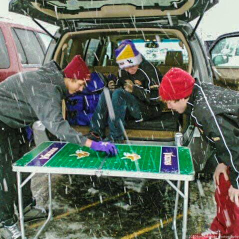 Boys playing a game in tailgating lot in the snow